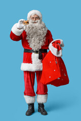 Santa Claus with tasty burger  on blue background