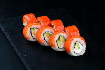 Set of maki sushi rolls Philadelphia with salmon, cream cheese, avocado, rice and nori.