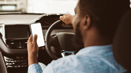 Car Navigation App. Unrecognizable Black Driver Guy Using Mobile Phone With Blank Screen Sitting In Automobile. Selective Focus, Mockup