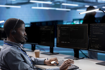Employee working in call center, providing outsourcing services for data center businesses. African...