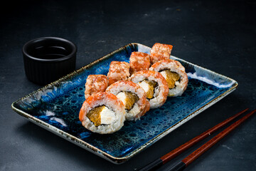 Traditional Japanese cuisine sushi rolls with salmon, shrimp, cream cheese and orange.