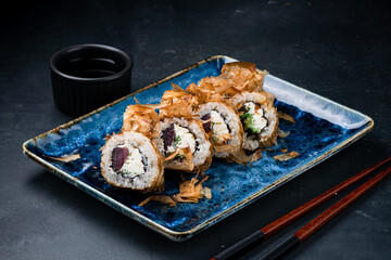 Set of sushi rolls with tuna, cream cheese, cucumber in dry shavings of tuna.