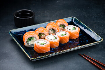 Japanese cuisine sushi rolls Philadelphia with salmon, cream cheese, cucumber, rice and nori.