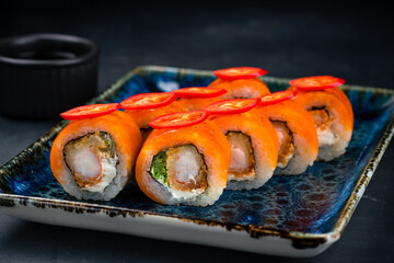 Set of maki sushi rolls with shrimp tempura, cream cheese, lettuce, cheddar cheese and chili...