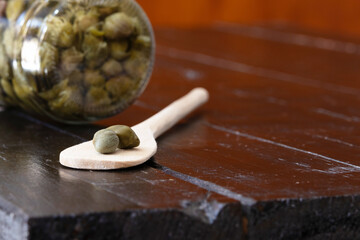 A wooden spoon with two capers