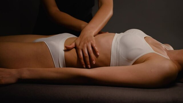 Close-up of a masseuse providing a relaxing abdominal massage