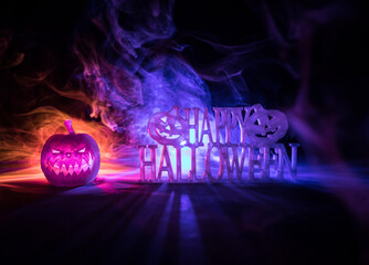 Halloween concept. Creepy silhouette in the dark corridor with pumpkin head. Toned light with fog...