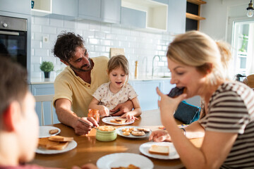 Family having breakfast together at the kitchen table