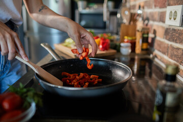 Young woman preparing fresh vegetables in a modern kitchen