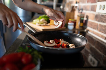 Young woman preparing fresh vegetables in a modern kitchen
