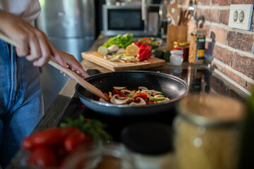 Young woman preparing fresh vegetables in a modern kitchen