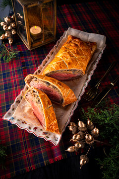 Beef wellington or boeuf en crout cut into slices on christmas background.