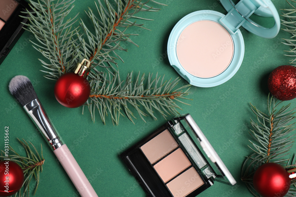 Poster Flat lay composition with makeup products and Christmas decor on green background