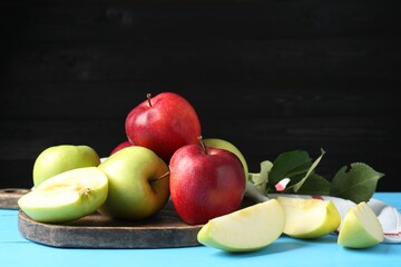 Fresh red and green apples on light blue wooden table