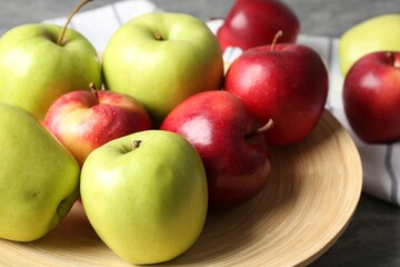 Fresh red and green apples on grey table, closeup