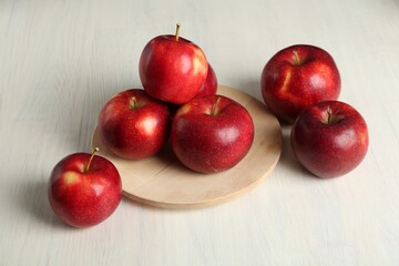 Fresh ripe red apples on white wooden table