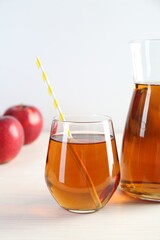 Fresh apple juice on white wooden table