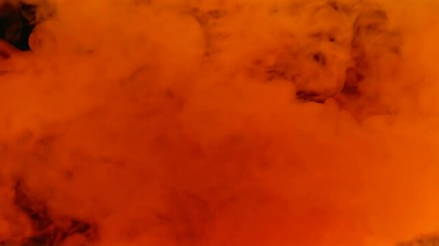 A large orange cloud of smoke, which is likely from a fire