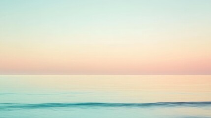 A soft, pastel-colored sunset over a calm, still ocean.