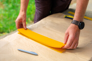 Man cuts beeswax blank for the production of decorative candles