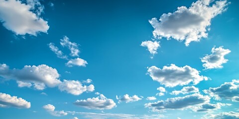 A clear and peaceful blue sky with scattered white clouds during a sunny day