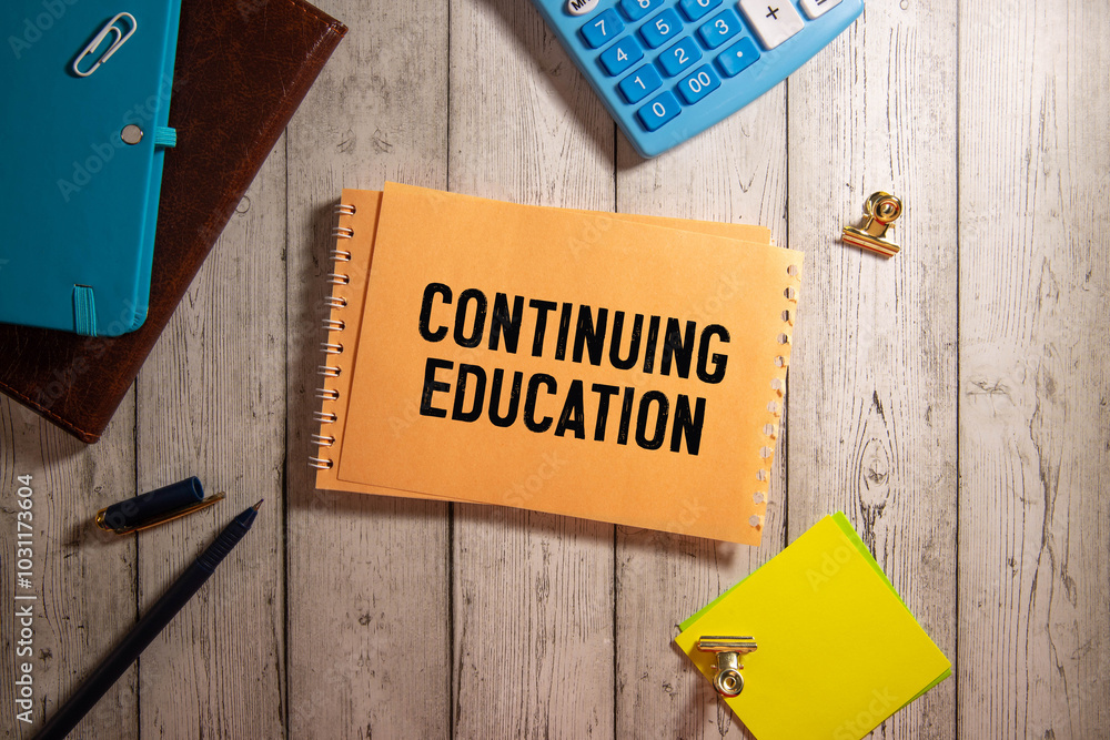 Poster continuing education. text on notepad on bright stiff backing