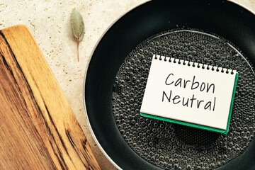 There is notebook with the word Carbon Neutral. It is as an eye-catching image.