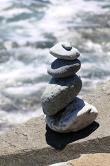 A close up of a rock cairn on a jetty at Dana Point, California