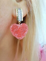 Blonde girl in gummies heart-shaped earrings.