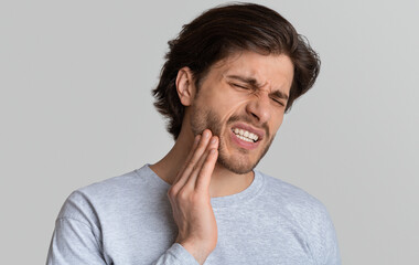 Dental problems concept. Man suffering from bad toothache, empty space