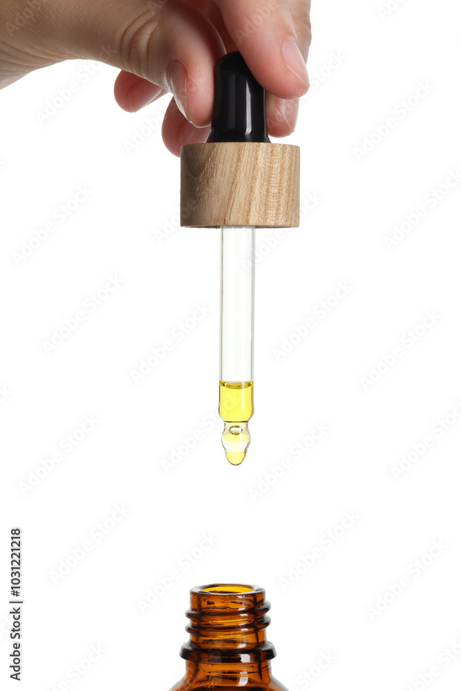 Sticker Woman dripping tincture from pipette into bottle on white background, closeup