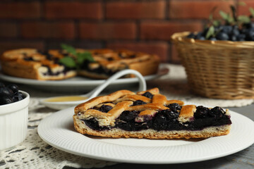 Piece of tasty homemade pie with blueberries on table, closeup