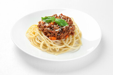 Plate with tasty pasta bolognese on white table, closeup