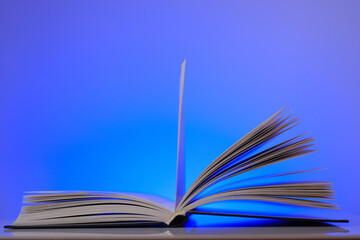 Reading and education concept.Open book on a blue background.Learning and knowledge 