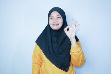 hijab woman gesture ok using hands. a sign is received