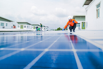 A worker in an orange safety jacket inspects solar panels on a rooftop, using a laptop to ensure proper maintenance. The scene highlights renewable energy, solar technology, and sustainable practices.