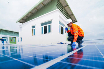 engineer man inspects construction of solar cell panel or photovoltaic cell by electronic device....