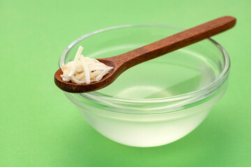 Cocos nucifera - Organic coconut water in glass bowl.