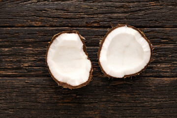 Cocos nucifera - Coconut pieces, tropical fruit on wooden background