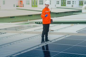 engineer man inspects construction of solar cell panel or photovoltaic cell by electronic device....