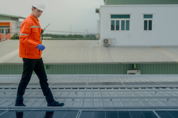 engineer man inspects construction of solar cell panel or photovoltaic cell by electronic device....