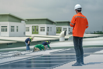 engineer man inspects construction of solar cell panel or photovoltaic cell by electronic device....