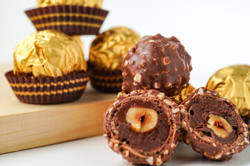 chocolate and hazelnut confectionery balls. chocolate sweet made. Chocolate candies in a gold wrapper