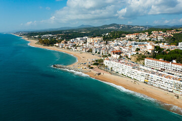 Fototapeta premium Birds eye view of Sant Pol de Mar, Spain. Residential building along Mediterranean sea coast and beach visible from above.