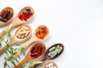 Vitamin capsules in a wooden spoon, soft gels, Fish oil capsules, omega 3, omega 9, vitamin D,...