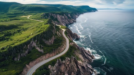 A scenic view of a road that runs along the edge of a cliff overlooking the ocean. The road is surrounded by lush green grass and rocky cliffs. The ocean is calm and the sky is clear
