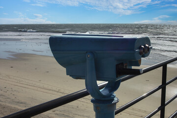Coin operated binoculars pier looking over the long sandy beaches of Huntington Beach