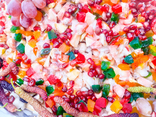 Colourful mix and fresh fruit chat, consistent on different types fruits slices, on market. Top view 