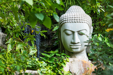 Lop Buri, Thailand - September, 20, 2024 :Buddha in the Green Embrace at Lop Buri, Thailand.