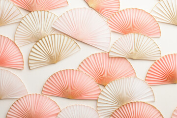 Pink and gold fan wallpaper, with elegant floral patterns, adorns the walls of a luxurious and sophisticated living room.